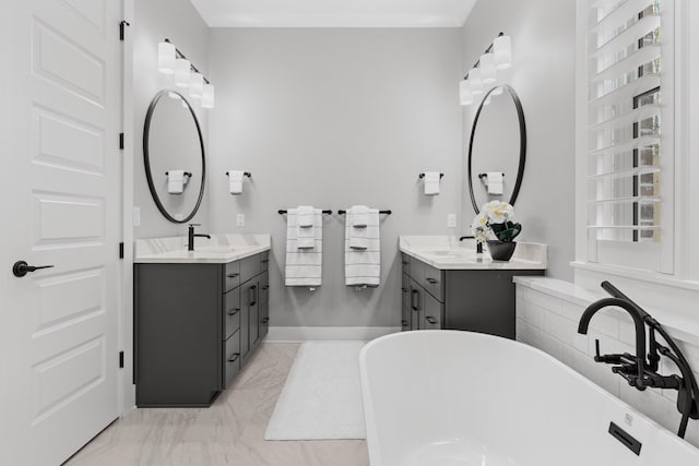 bathroom featuring vanity and a bath