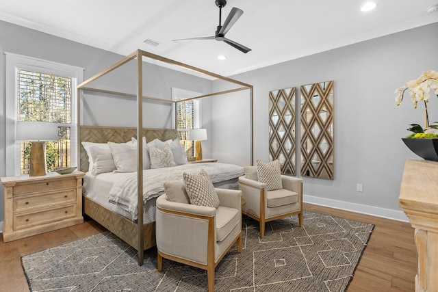 bedroom featuring dark wood-type flooring, ceiling fan, and crown molding