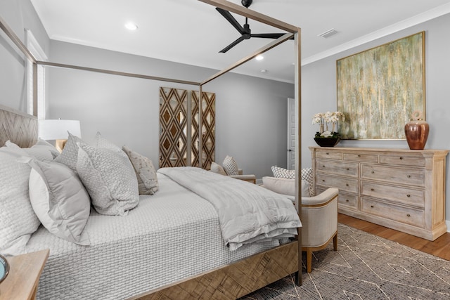 bedroom with ornamental molding and dark hardwood / wood-style floors