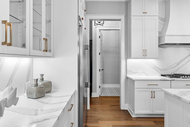 kitchen featuring white gas cooktop, white cabinetry, light wood-type flooring, and custom exhaust hood