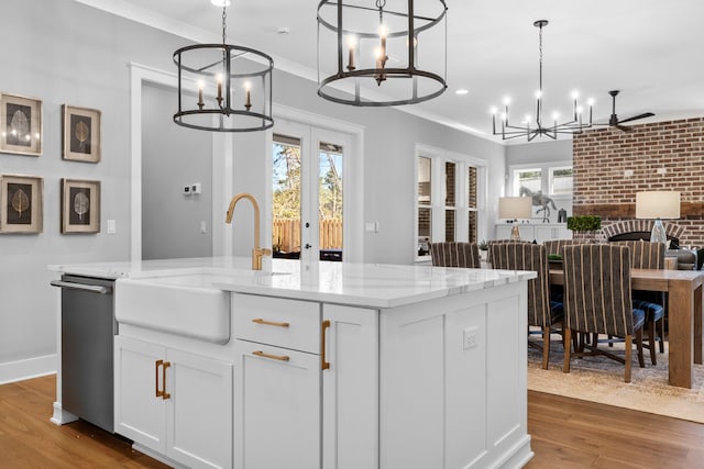 kitchen featuring dark wood-type flooring, pendant lighting, a wealth of natural light, and sink