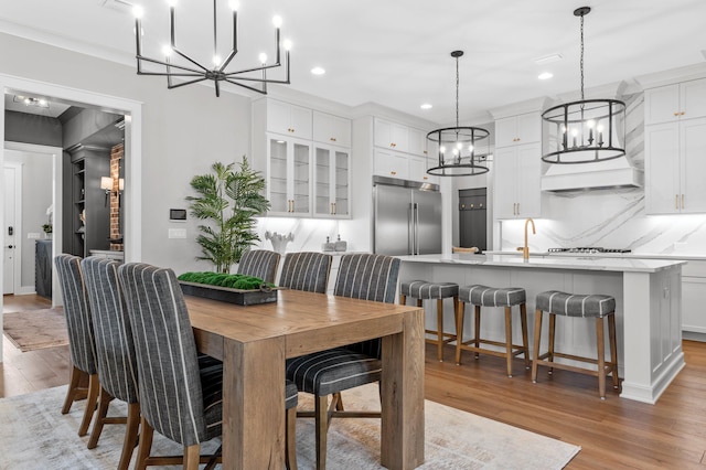 dining room featuring light wood-type flooring and ornamental molding