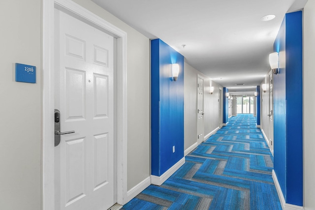 corridor with dark colored carpet