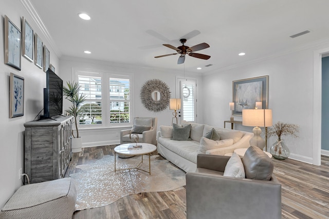 living room featuring wood-type flooring, ceiling fan, and crown molding