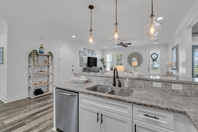 kitchen with wood-type flooring, crown molding, white cabinetry, sink, and stainless steel dishwasher