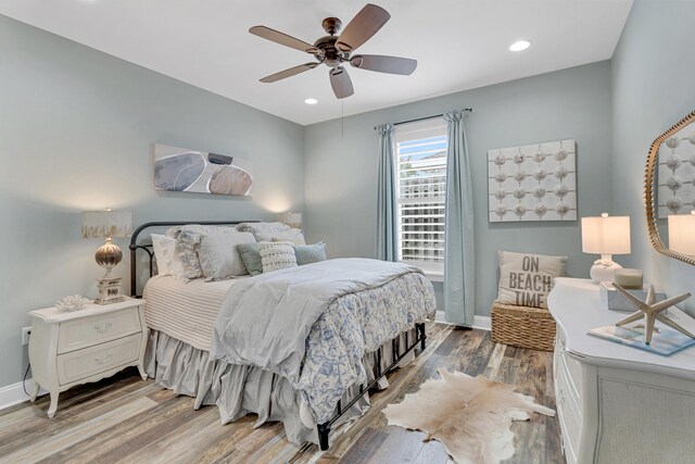 bedroom with wood-type flooring and ceiling fan