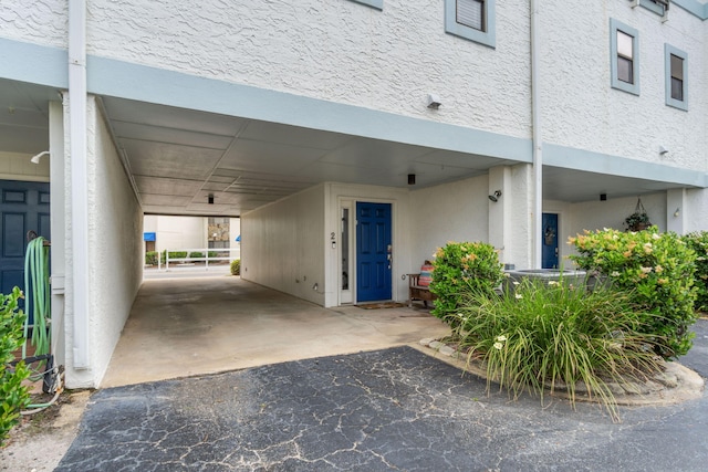 view of exterior entry with stucco siding