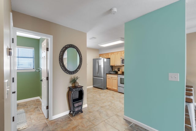 hallway featuring baseboards