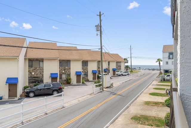 view of asphalt road featuring sidewalks