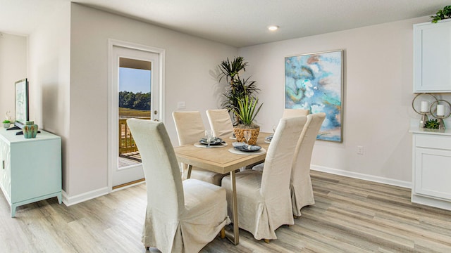 dining area with light hardwood / wood-style floors