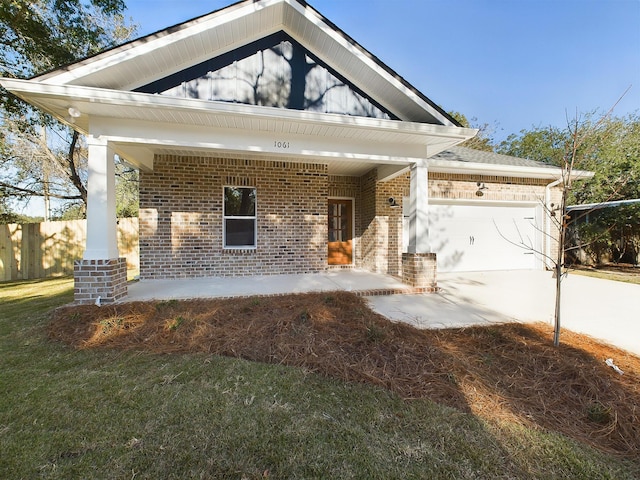 view of front of home with a front yard and a garage