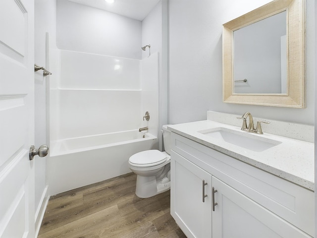 full bathroom featuring hardwood / wood-style flooring, toilet, vanity, and bathing tub / shower combination