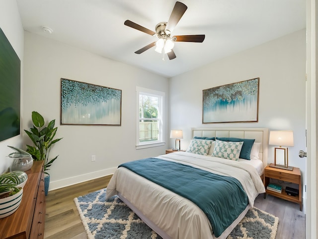 bedroom with hardwood / wood-style flooring and ceiling fan