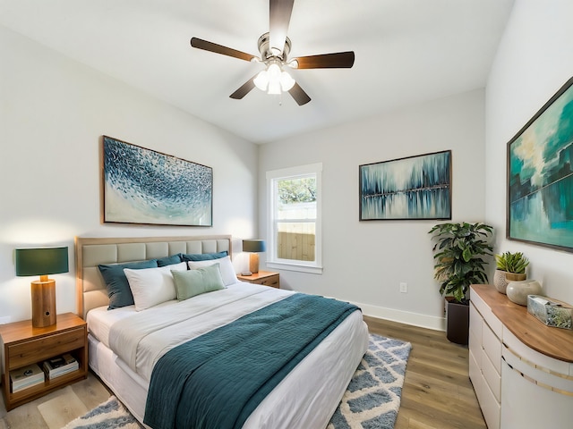 bedroom with ceiling fan and hardwood / wood-style floors