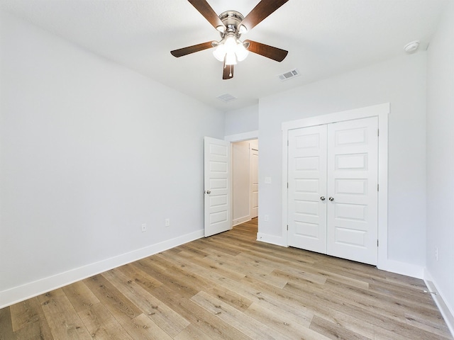 unfurnished bedroom with ceiling fan, a closet, and light hardwood / wood-style flooring