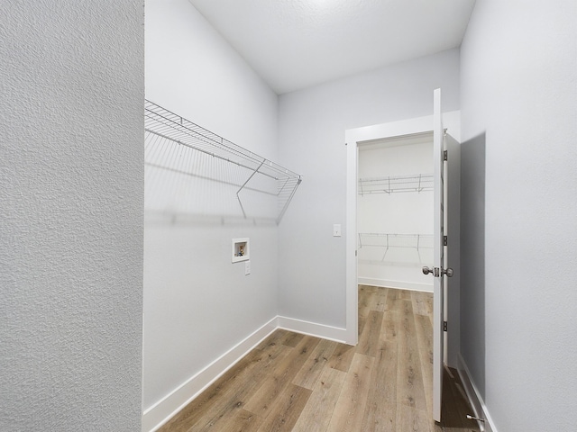 laundry area with washer hookup and light wood-type flooring