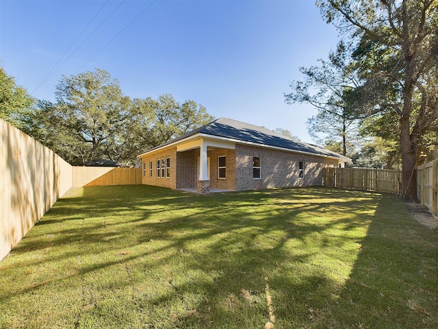 rear view of property with a lawn