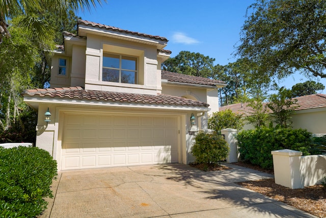 mediterranean / spanish home featuring a garage