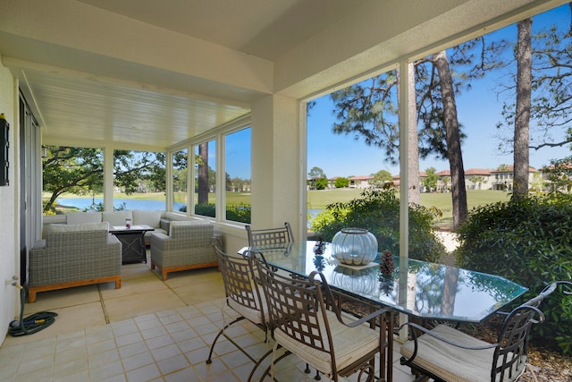 sunroom / solarium featuring a water view