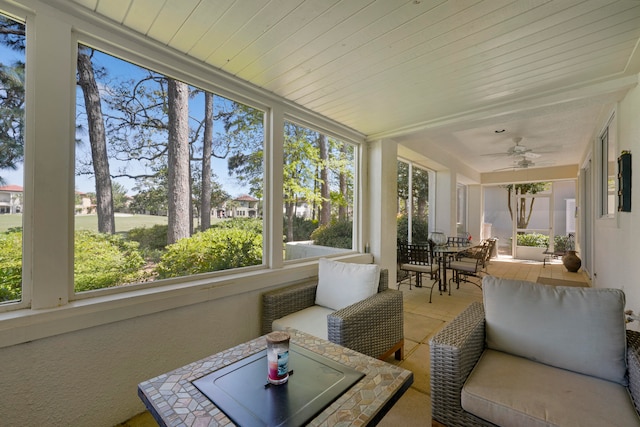 sunroom / solarium featuring ceiling fan