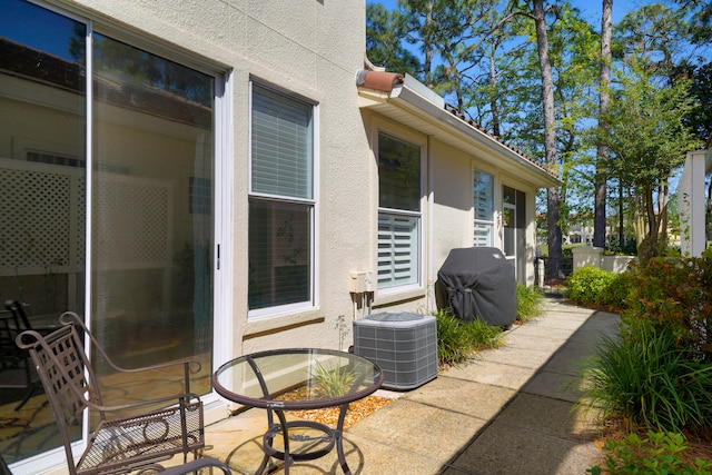 view of patio featuring cooling unit and a grill