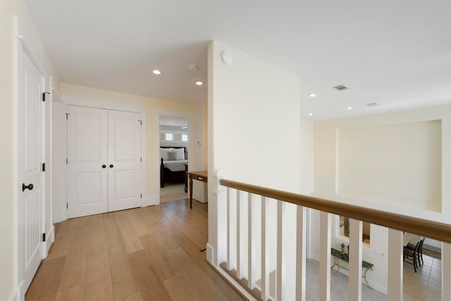 hallway with light hardwood / wood-style flooring