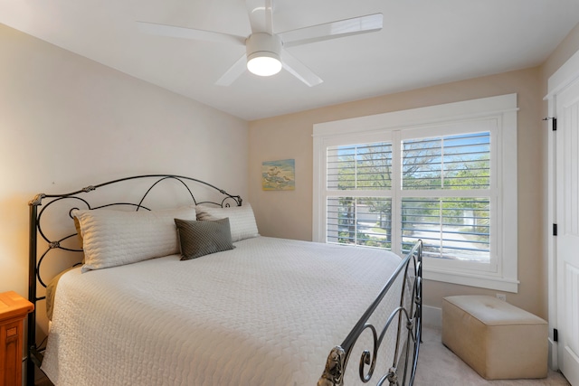 bedroom with light carpet and ceiling fan