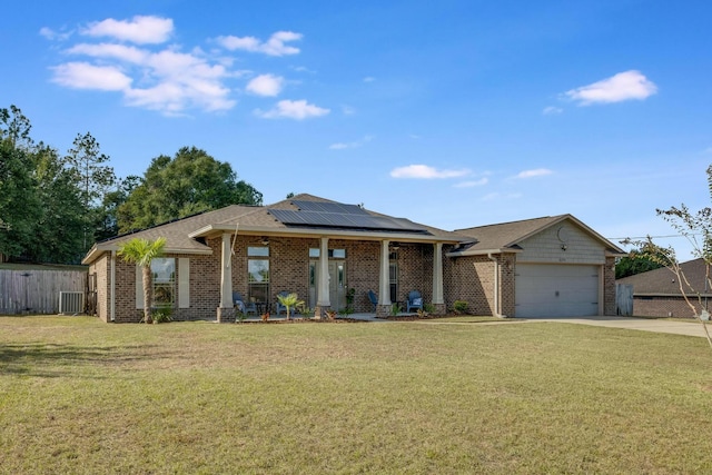 single story home with solar panels, a front lawn, cooling unit, a garage, and a porch