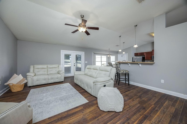 living room with dark hardwood / wood-style floors, ceiling fan, and vaulted ceiling