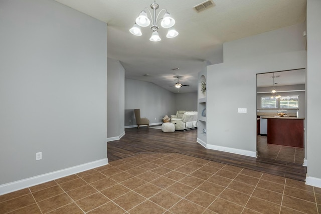 spare room with hardwood / wood-style floors and ceiling fan with notable chandelier