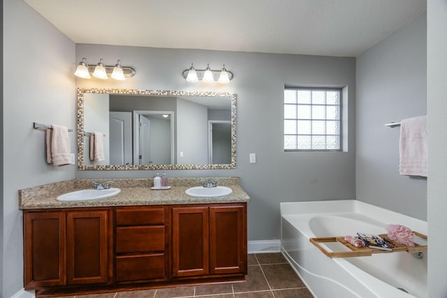 bathroom with vanity, tile patterned floors, and a bathing tub