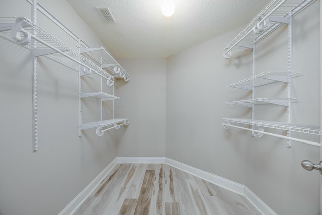 spacious closet featuring hardwood / wood-style floors