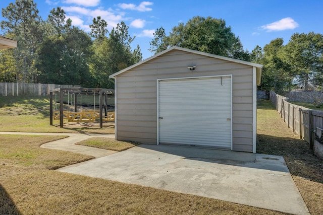 view of outdoor structure with a lawn and a garage