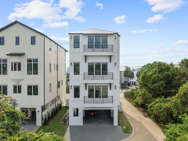 32 Cote Dazur Dr, Santa Rosa Beach, FL 32459 - view of front of property featuring stucco siding, a carport, driveway, and a balcony