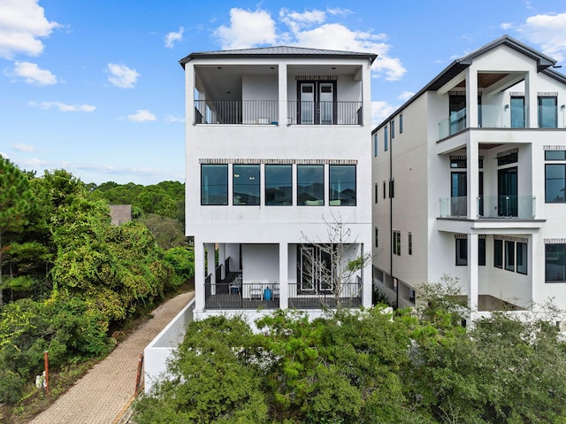 32 Cote Dazur Dr, Santa Rosa Beach, FL 32459 - view of front facade featuring stucco siding and a balcony