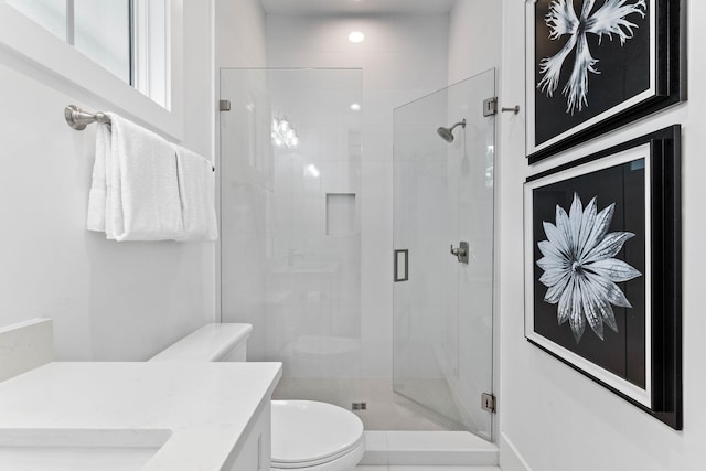 bathroom with vanity, toilet, and an enclosed shower