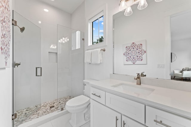 bathroom featuring vanity, an enclosed shower, toilet, and tile patterned flooring