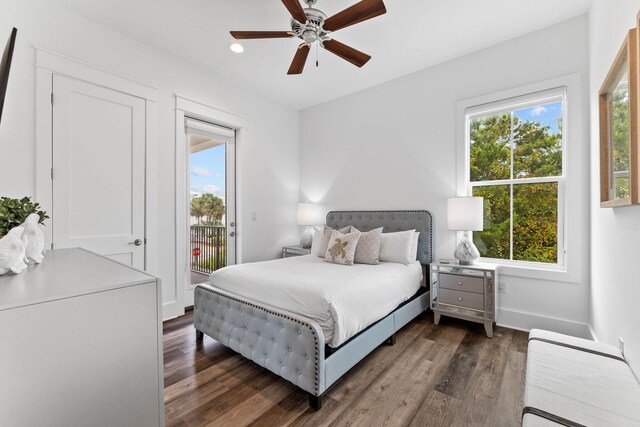 bedroom with ceiling fan, access to outside, multiple windows, and dark hardwood / wood-style floors