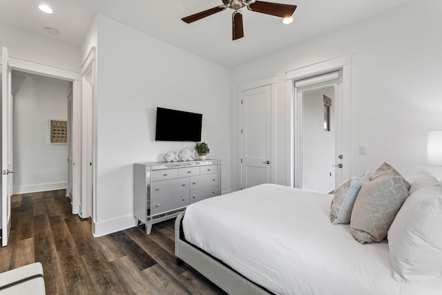 bedroom with dark hardwood / wood-style flooring and ceiling fan