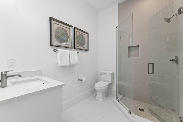 bathroom with vanity, toilet, tile patterned floors, and a shower with door