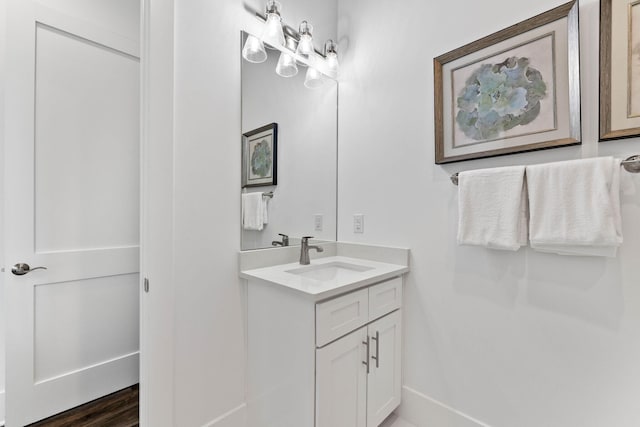 bathroom with hardwood / wood-style floors and vanity