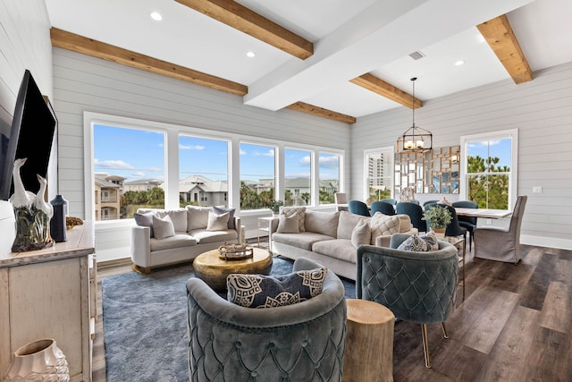 living room featuring beam ceiling, wood walls, plenty of natural light, and dark hardwood / wood-style floors