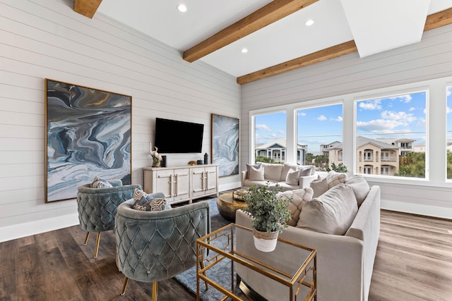 living room featuring beamed ceiling, hardwood / wood-style flooring, and wooden walls