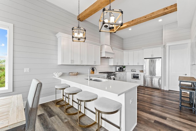 kitchen featuring dark hardwood / wood-style flooring, stainless steel appliances, sink, beamed ceiling, and white cabinetry