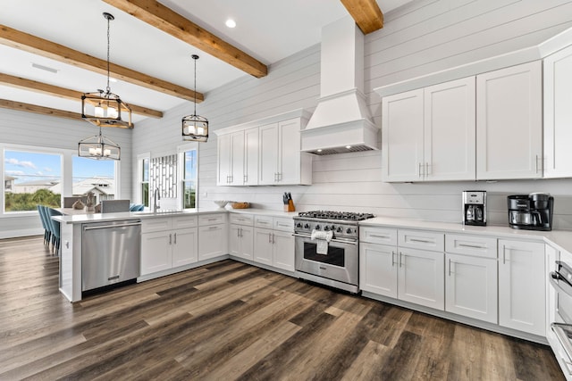 kitchen featuring premium range hood, white cabinets, pendant lighting, beamed ceiling, and stainless steel appliances