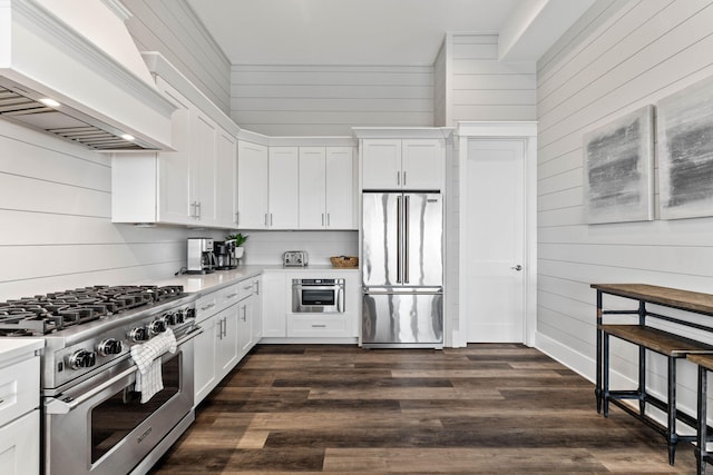 32 Cote Dazur Dr, Santa Rosa Beach, FL 32459 - kitchen featuring premium appliances, premium range hood, light countertops, wood walls, and white cabinets