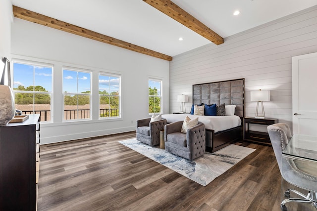 bedroom featuring beamed ceiling, dark hardwood / wood-style floors, and wooden walls