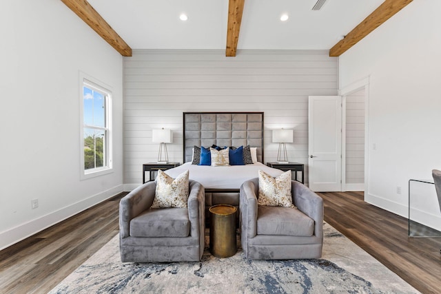 bedroom featuring wood walls, dark hardwood / wood-style flooring, and beamed ceiling