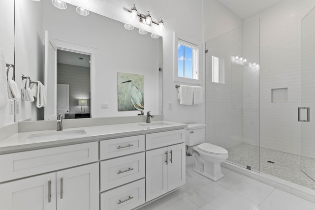 bathroom featuring vanity, toilet, and a shower with door