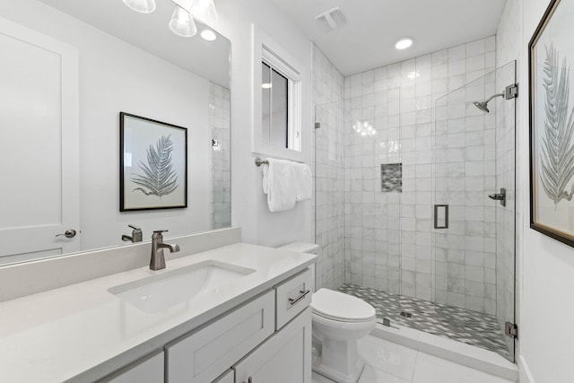 bathroom featuring tile patterned floors, vanity, an enclosed shower, and toilet